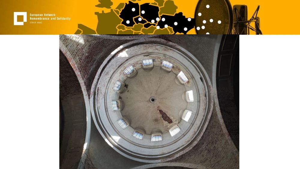 Presentation slide with a single photo in the center. It presents a view of the inner side of a church dome. It is visibly in a neglected condition, with some of the white plaster fallen off, revealing a brick wall underneath. Above all of it, a gold-yellow header with European Network remembrance and Solidarity.