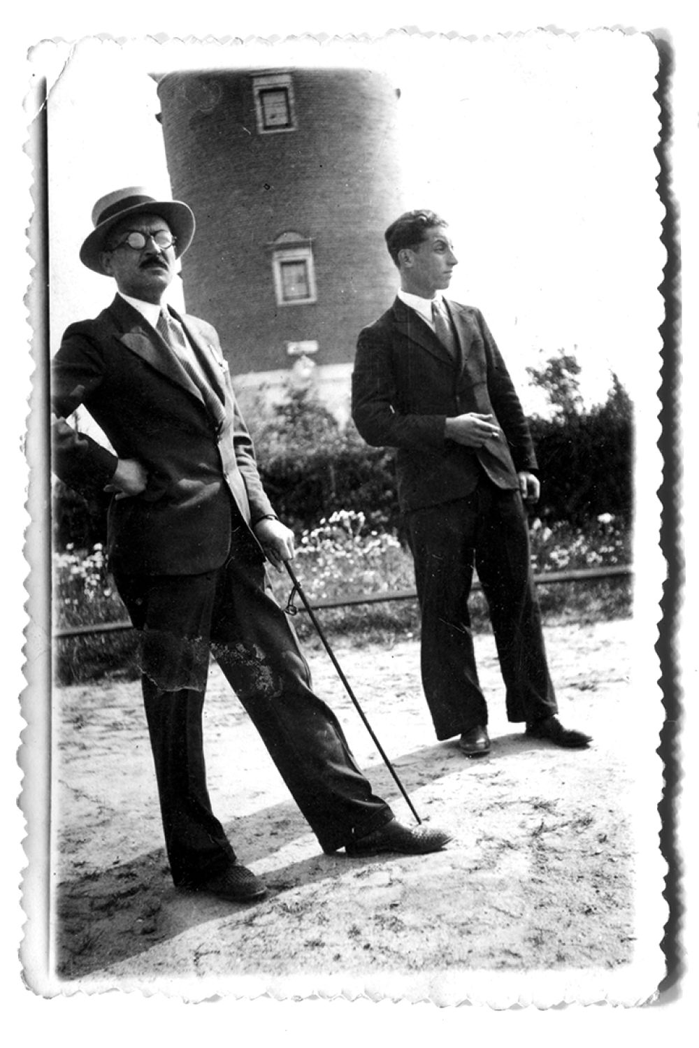 This photograph features my great-grandfather, Kazimierz (in the back) and one of his brothers, Bolesław, called Bolek, during a Sunday stroll in Ozorków in late 1930s.  
All of the siblings shared a passion for newly available photography and Bolek, as my grandpa recalled, ”was the happiest and the most handsome one.” 
During the second world war, Bolek kept his job in the city hall’s road department, but worked in conspiracy against the Germans, passing on secret information. During spring of 1942 was exposed and arrested along with his colleagues from Łódź. He died later that year after a brutal interrogation in the headquarters of Gestapo, leaving behind his wife and daughter.  
The headquarters, nowadays a school, is two steps from my current flat and every time I pass by it during my Sunday strolls, I can’t help remembering this story. 
The cheerful family time seen in the photographs my ancestors left behind was forever broken, which was a case for many civilian families in Poland during the war. 

Although it is not easy to put together the facts, I keep researching the archives to recreate as much of his life’s story as possible. The least that can be done is to remember.