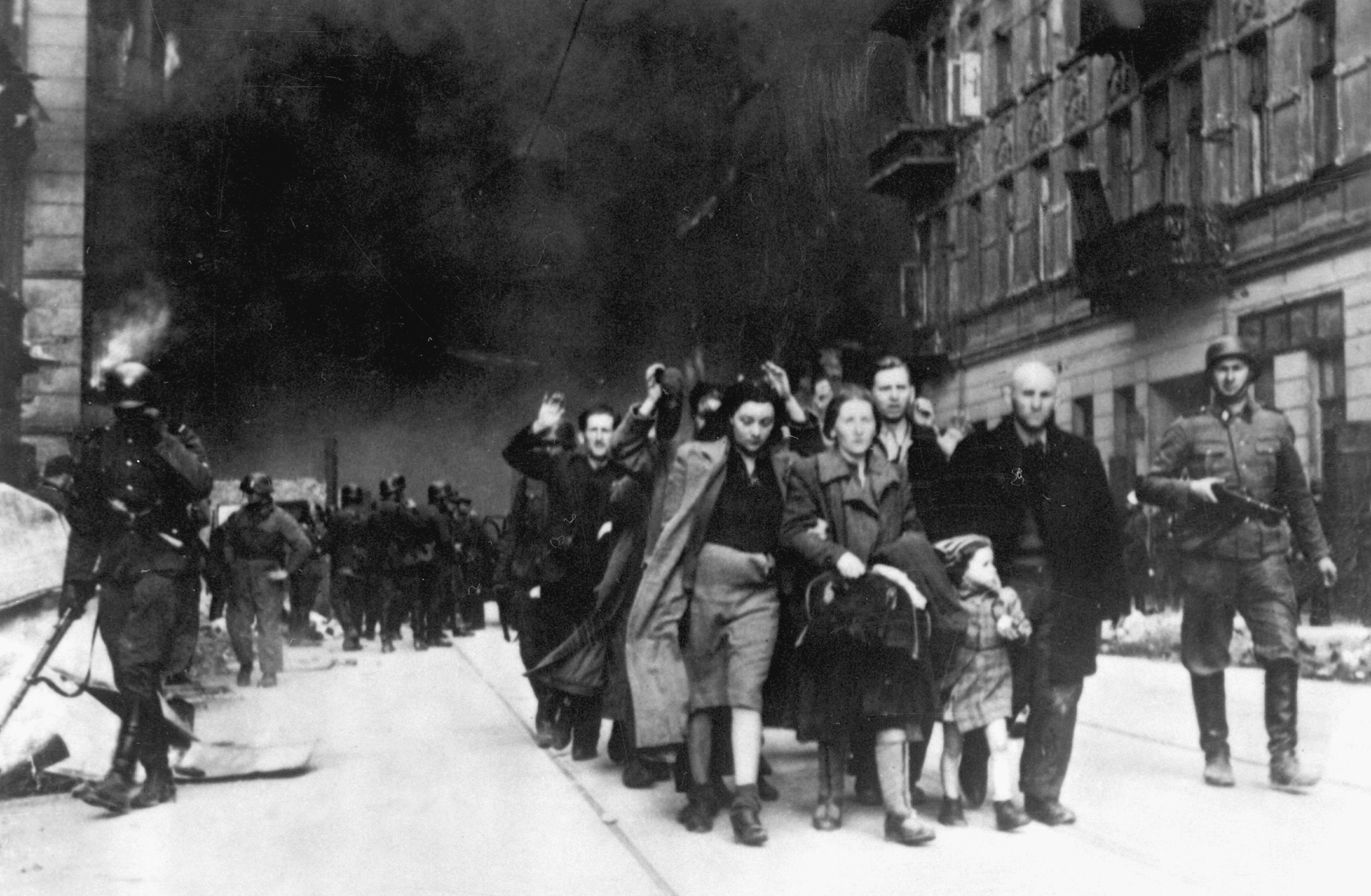 Captured Jews are led by German troops to the assembly point for deportation. Picture taken at Nowolipie street, near the intersection with Smocza. Photo from Jürgen Stroop Report to Himmler.