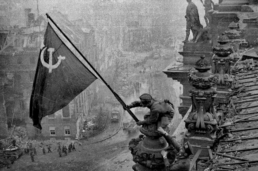 Raising a Soviet Flag over the Reichstag, taken during the Battle of Berlin on 2 May 1945.